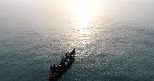Fishermen Sailing on Ocean at Sunrise