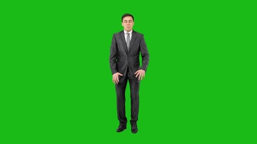 Surprised Young Businessman Standing in Studio and Looking at Camera