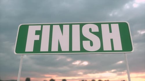 Finish Line Road Sign Against Dramatic Cloudy Sky at Sunset
