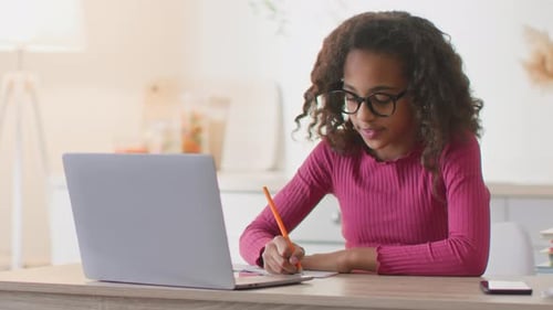 Girl studying with laptop at home