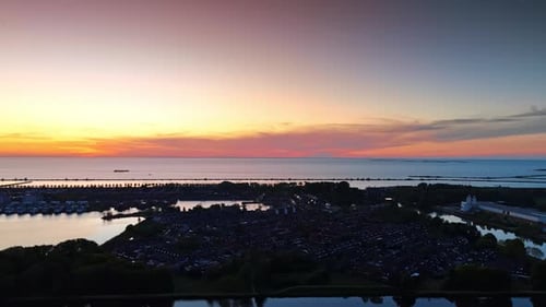 Scenery of dark village on the water at dusk time.