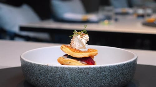 Gourmet Dish with Layered Pancakes and Garnish Served