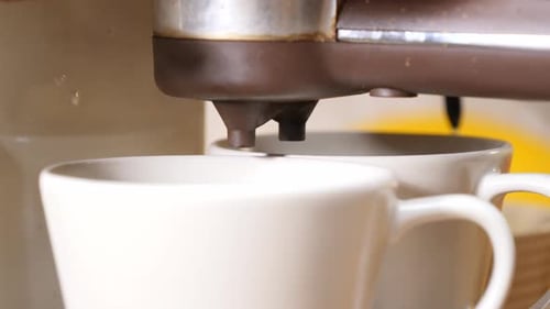 Coffee Pouring from Coffee Maker into Mugs