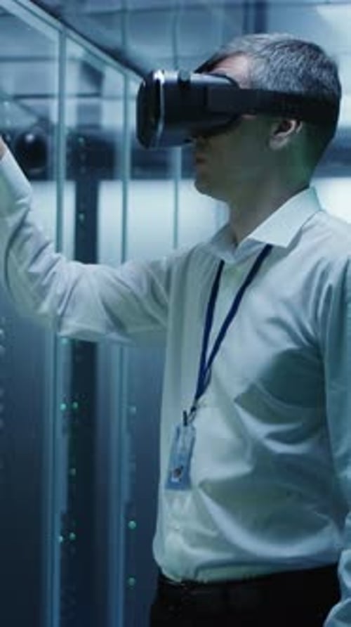 Man in VR Glasses Working in a Data Center