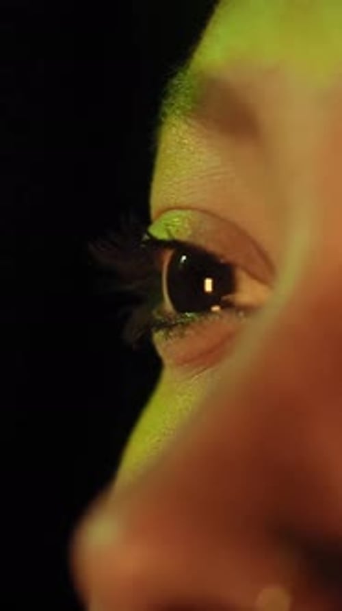Close Up of Woman Eyes in Colorful Light of TV Television Reflection Pretty African American Girl