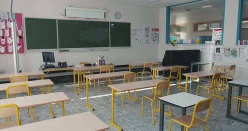 Empty Classroom with Desks and Chalkboard