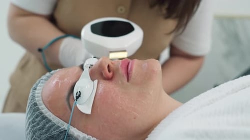 Woman Receiving Laser Treatment in Cosmetic Clinic