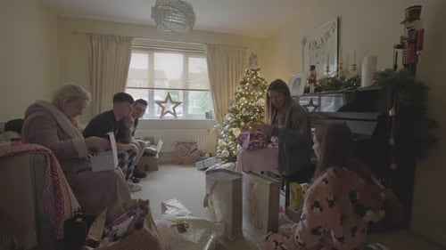 Family Christmas morning gathering exchanging gifts, happy memories