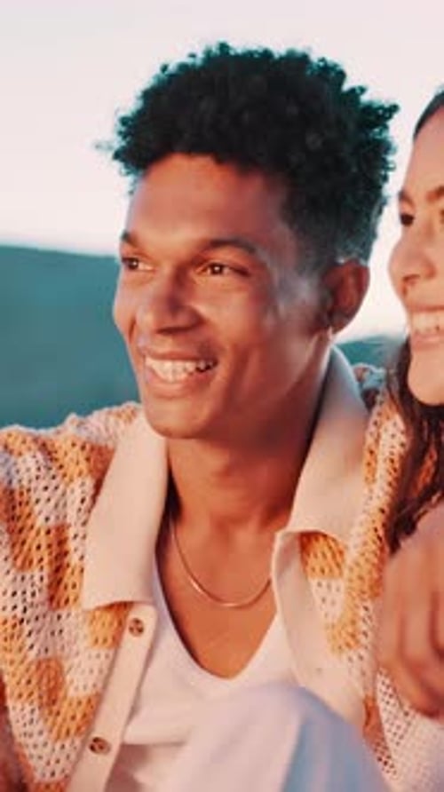 Smiling Couple Enjoys Beachside Moment Together