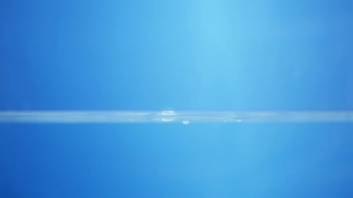 Mesmerizing Water Droplets Creating Ripples on Water Surface