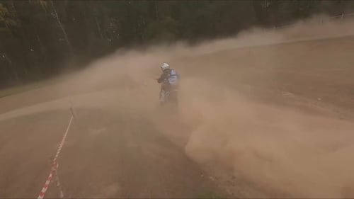 Motorcyclist in Helmet Rides Bike Around Circle Along Field