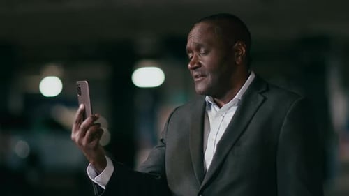 Adult Using Smartphone in Urban Environment at Night