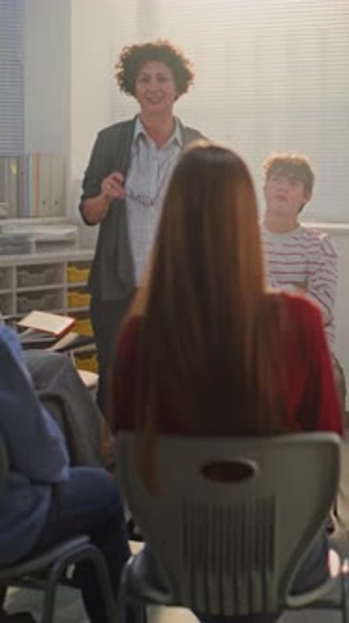Female Teacher Guides Teenage Girl in Center of Circle Through Emotional Improvisation Exercise