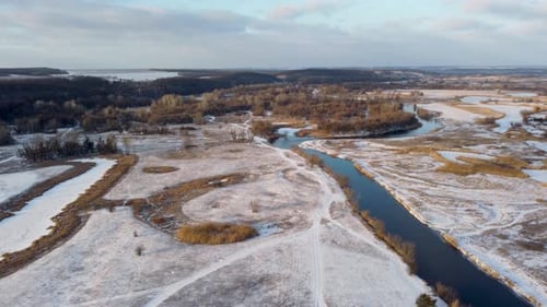 Aerial winter rural view on snowy river valley
