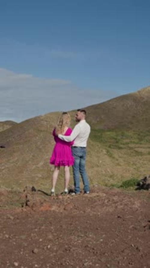 Couple Embracing on Mountain Top with Scenic Landscape