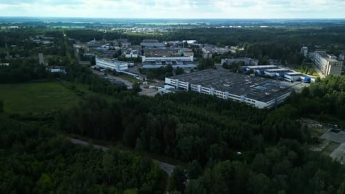 An Expansive View Reveals an Industrial Complex Nestled Amidst Lush Forest Captured From an Aerial