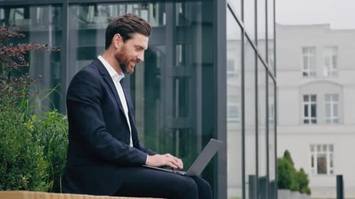 Side View Handsome Positive Businessman Typing on Laptop Remote Working Outdoors Male Professional