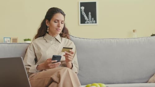 Woman shops online with cell phone