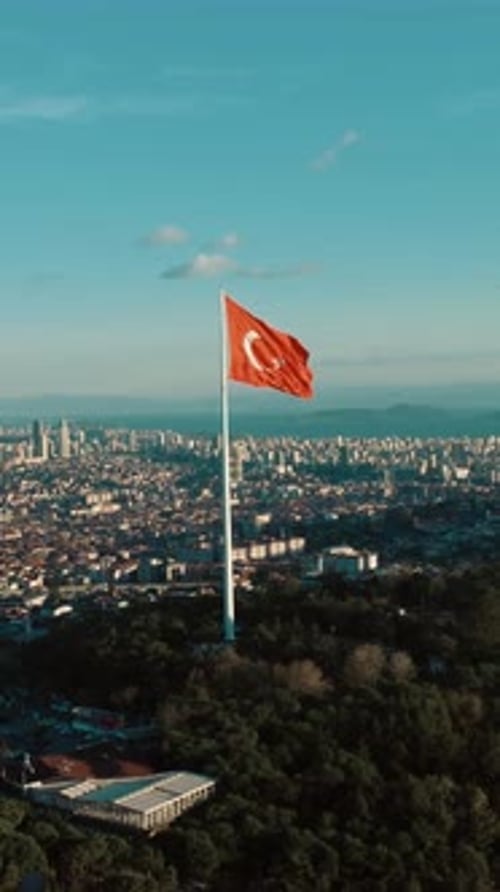 Aerial view of Turkish flag waving over city