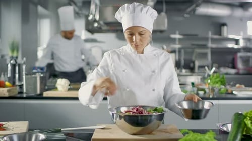 In a Famous Restaurant Female Cook Prepares Salad. She Works in a Big Modern Kitchen.