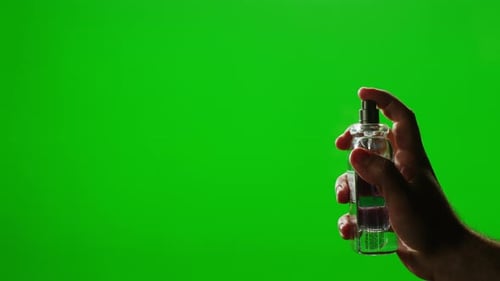 Young Man Applying Perfume to Skin on Chroma Key Green Screen Close Up of Spraying Deodorant Luxury