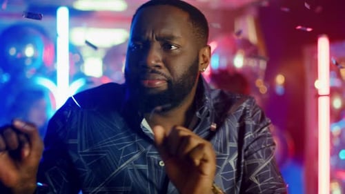 Portrait of Emotional Afro Guy Making Moves on Neon Lamps Background. Closeup