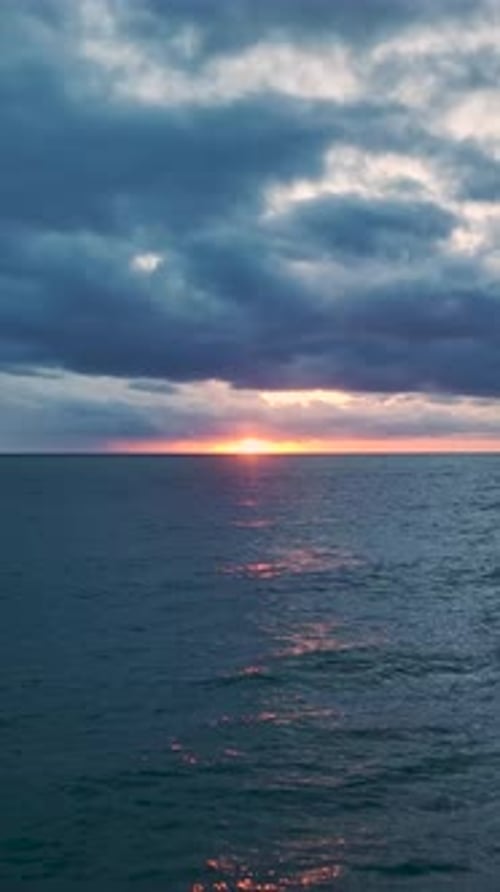 Vertical Video Scenic Sunset With Bright Colors Illuminating the Sky and Reflecting on the Ocean