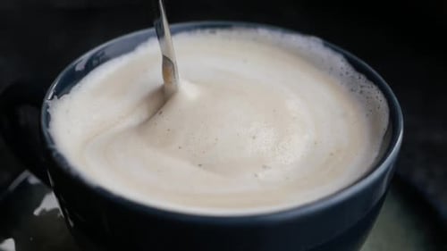 Close Up of Coffee Being Stirred with Spoon