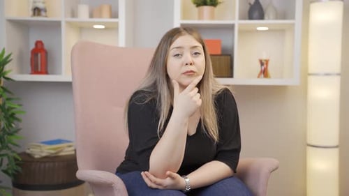 Pensive Woman Thinking Deeply in Armchair