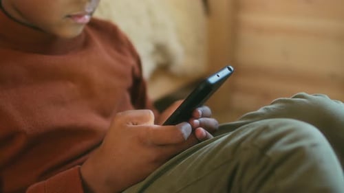 Child Using Mobile Phone Indoors