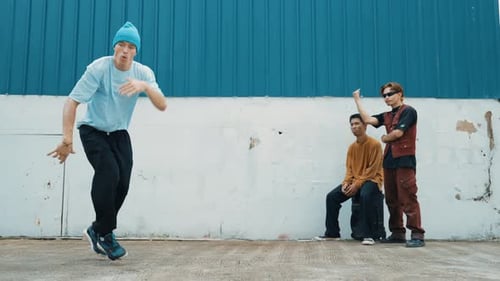 Young street dancer dancing in hip hop style with friend cheer behind. hiphop.
