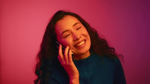 Young Adult Smiling While Talking on Phone