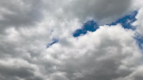 Thick cumulus clouds gathering in the sky. Quick cloudscape transformation timelapse.