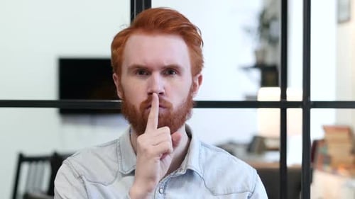 Gesture of Silence By Young Man Finger on Lips