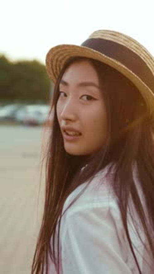 Young Woman Smiling into Camera During Golden Hour