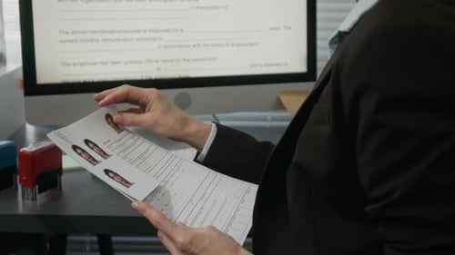 Mature Female Consulate Employee Checking Work Visa Application