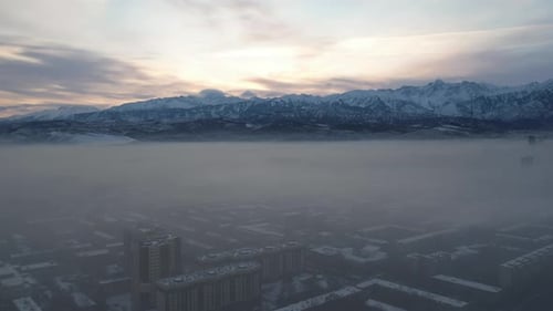 Dawn Over the City in Fog and Smog