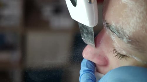 Skincare and Machine Cosmetology in Spa Centre Cosmetician Using Ultrasonic Device for Cleaning Face