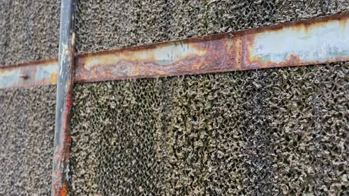 Close-Up of Rusty Metal Frame and Industrial Mesh Texture