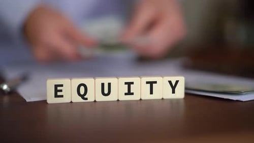 Concept of Equity. Selective focus with cash on the background.