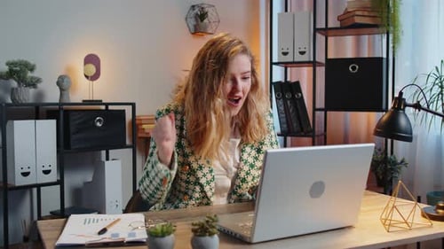 Woman Works on Laptop Then Celebrates Success