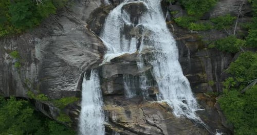 Beautiful Landscape of High Waterfall with Falling Down Clear Water From Rocky Boulders Between