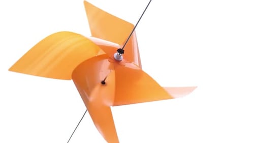 Orange Pinwheel Spinning Against White Background