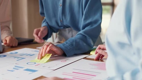 Asia people meeting brainstorming ideas about new paperwork project in office.