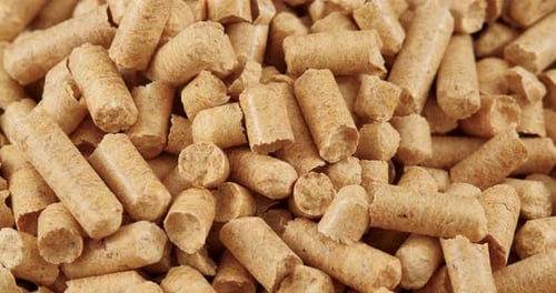 Close-up Rotation of Compacted Wooden Sawdust Pellets As Natural Cat Litter Filler or Organic Fuel.