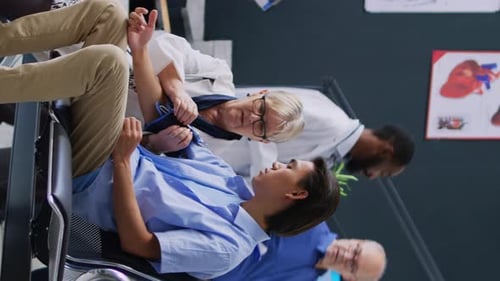Mature Doctor Checks Patient Blood Pressure in Clinic