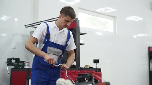 Mechanic Assembles Engine Installs Crankshaft in Cylinder Block at Modern Workshop Professional Uses