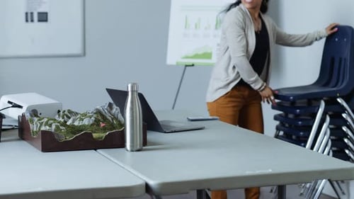 Woman Prepares Presentation in Office Meeting Room