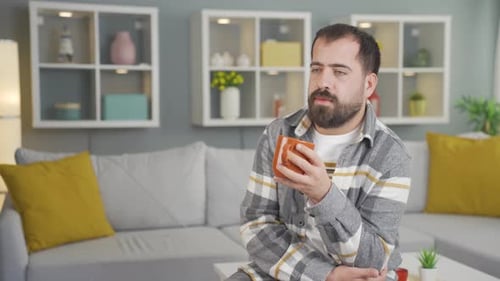 Man with Beard Holding Mug Indoors