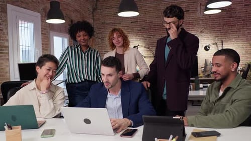 Diverse Team Collaborates Around a Table in an Office